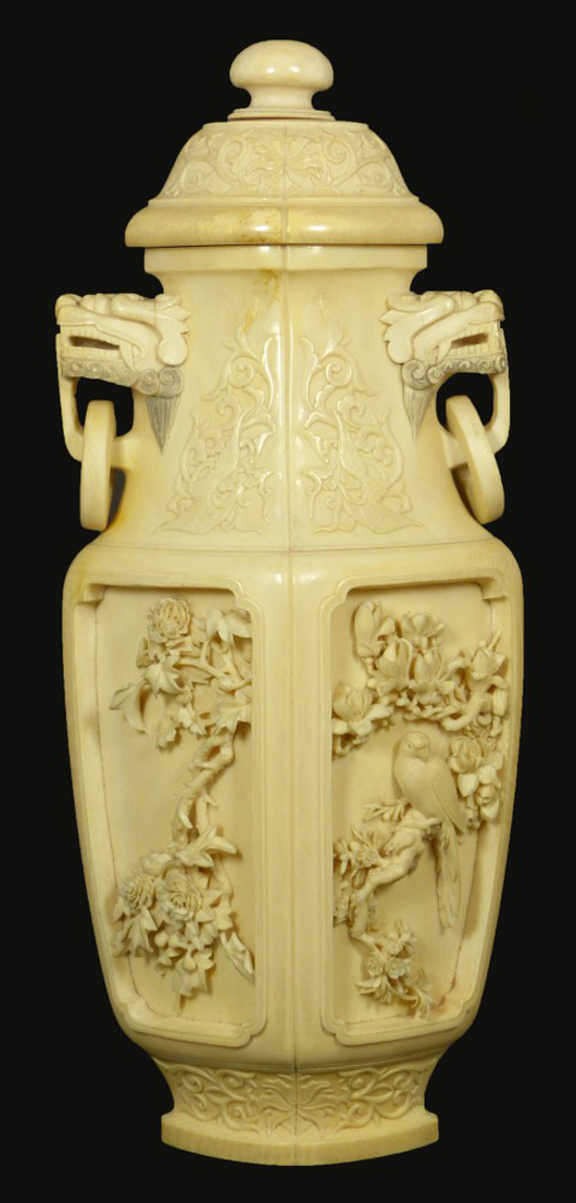 Chinese carved African ivory covered vase depicting scenes of birds of paradise, trees, flowers. Elite Decorative Arts image.