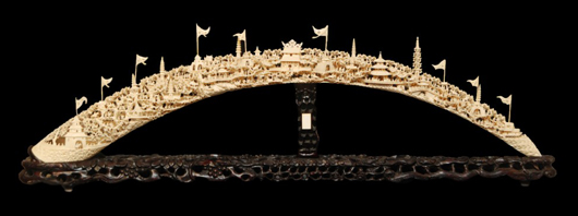 Massive Chinese carved and reticulated village scene carved from an African ivory tusk. Elite Decorative Arts image.