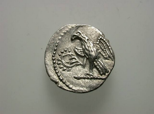 An ancient coin from the cache returned to its country of origin, Romania. Photo source: National History Museum, Bucharest.