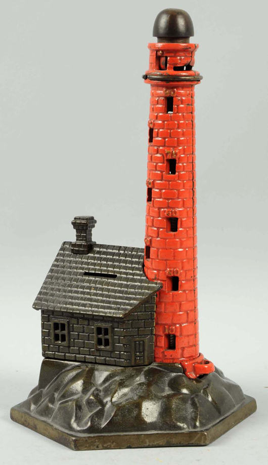 Lighthouse cast-iron mechanical bank with realistically detailed red brick tower, $10,800. Morphy Auctions image.