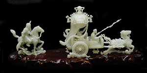 Chinese hand-carved white jade sculpture depicting a chariot with horses and riders. Price realized: $40,120. Elite Decorative Arts image.