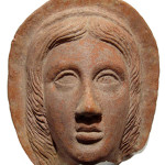 Etruscan terracotta relief of a facing female head, circa fourth-second century B.C. Ancient Resource LLC image.