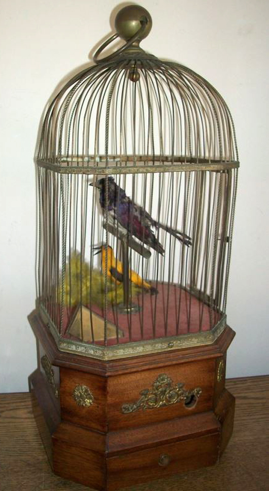 Penny in the slot signing birds in cage. Unique Auctions image.