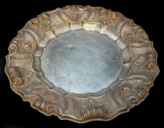 Ditta Torchiana & Loda 800 silver repousse charger with floral design and scalloped rim (est. $1,000-$1,200). Elite Decorative Arts image.