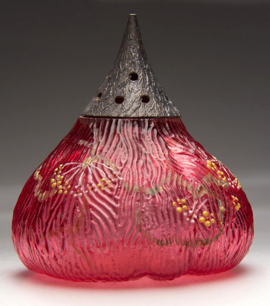 Made by Mount Washington Glass Co., this fig-shape sugar shaker in cased cranberry with polychrome floral decoration sold for $3,335 against the $1-2,000 estimate. Jeffrey S. Evans & Associates image.