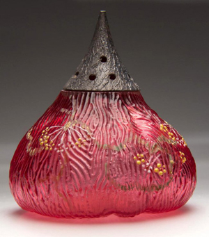 Made by Mount Washington Glass Co., this fig-shape sugar shaker in cased cranberry with polychrome floral decoration sold for $3,335 against the $1-2,000 estimate. Jeffrey S. Evans & Associates image.