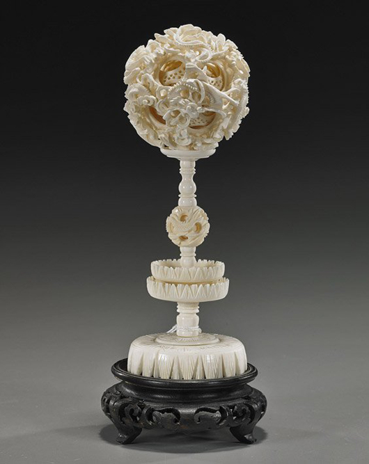 Chinese carved ivory puzzle ball with elaborate openwork design of writhing dragons among clouds on the exterior and with at least 10 interior openwork concentric balls, 8 inches. Estimate: $400-$600. I.M. Chait Gallery/Auctioneers image.