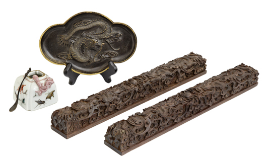 The auction will feature a fine selection of Chinese items, including two zitan scroll weights. Crescent City Auction Gallery LLC image.