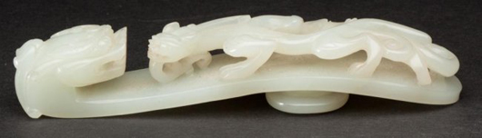 Jade buckle, in the form of a dragon, late 19th or 20th century, 5 1/2 inches long. Sold for $7,475 against $100-$200 estimate. Jeffrey S. Evans & Associates image.
