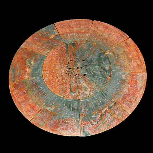A celadon jade bi disc with nine sections and inscriptions from the ‘Book of Han’ and Fujiezi and Taotie masks on reverse. From the family Collection of Liu Yunke (1792 - 1864), governor of Zhejiang. Gianguan Auctions image.