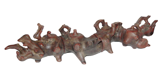 Zisha teapot of dragon form, naturalistically fired in the shape of a tree stump cut off in four sections. A two-character maker’s mark, Jiang Rong is impressed on the body of each section. Gianguan Auctions image.