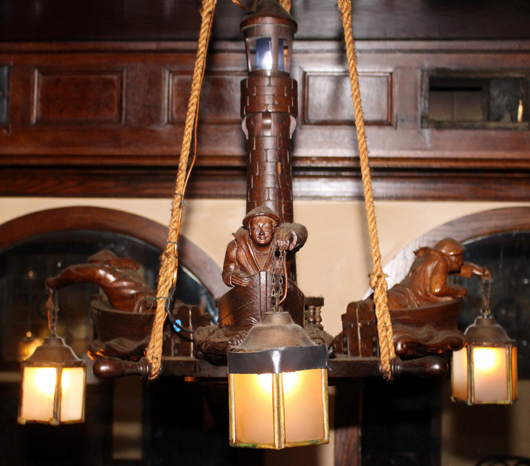 Wonderful appointments such as this heavily carved wood chandelier showing Oriental figures in boats will be sold. Ahlers & Ogletree Inc. image.