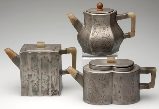 Group of pewter-clad 19th century Chinese Export teapots, with jade handles and spouts from the Teapot Extravaganza section of the auction. These teapots have an entire red- or white-ware clay teapot within the cladding. Jeffrey S. Evans & Associates image.