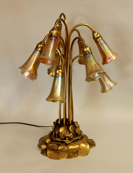 Tiffany Studios 10-light lily lamp on a gilt bronze lily plant base and having 10 stems. Price realized: $21,240. Ahlers & Ogletree image.
