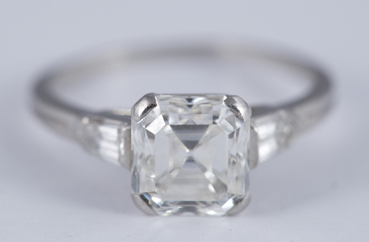 Tiffany & Co. platinum ring with emerald step-cut diamond, surrounding bullet-shape diamonds, total weight 2.15 carats, est. $10,000-$15,000. Quinn & Farmer image.