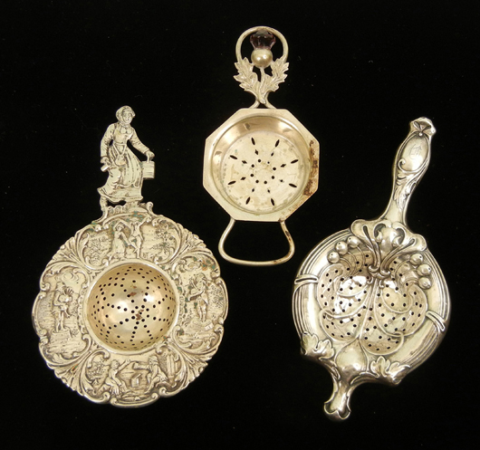 Grouping of three sterling silver and .800 silver tea strainers. Stephenson's Auctioneers image.