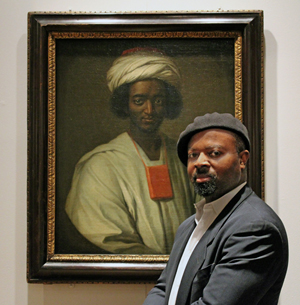 Ben Okri with the portrait of Ayuba Suleiman Diallo by William Hoareby Matthew Lewis, 2013. Copyright: National Portrait Gallery, London.