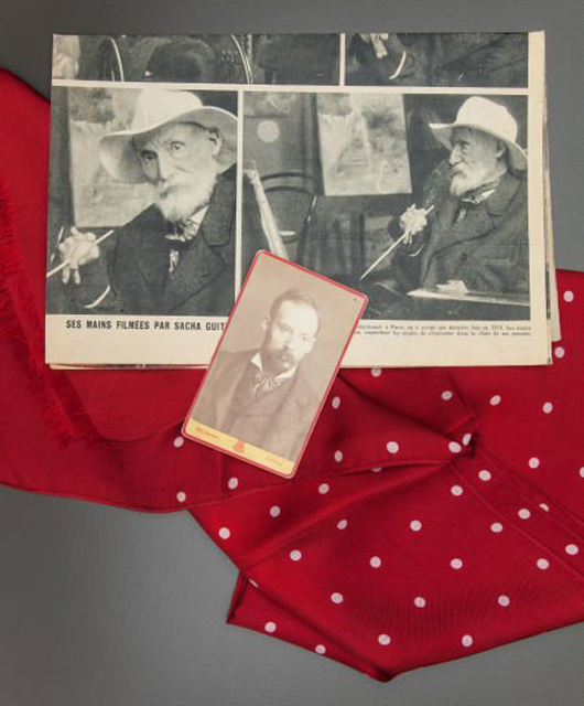 One of the unique items being sold is Renoir's silk scarf, 50 by 16 1/2 inches, accompanied by a photograph and newspaper article that show the artist wearing it. Image courtesy Heritage Auctions. 