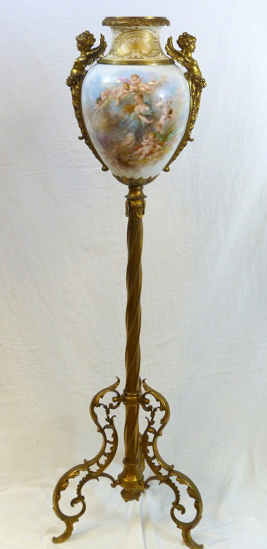 Antique French hand-painted porcelain urn having dore gilt bronze frame and stand (est. $12,000-$18,000). Elite Decorative Arts image.
