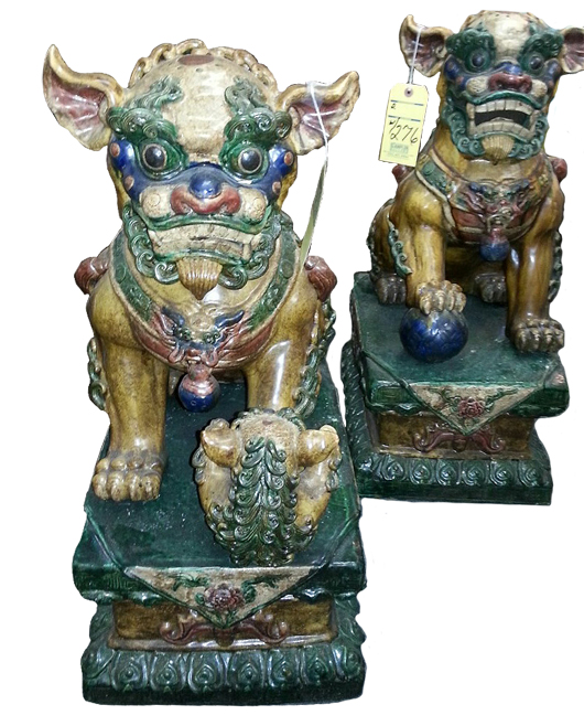 Pair of ornate foo dog figures on pedestals. Stampler Auctions image.