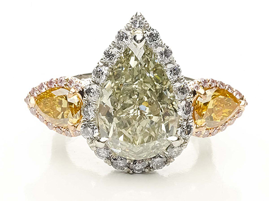 Platinum ring with 20K gold mounting containing 5.16ct pear shaped fancy deep grayish yellowish green GIA certified natural-colored diamond. Surrounded by 26 round pink diamonds weighing approximately .14ct tw, 18 round blue diamonds weighing approximately, .74 ct tw, 65 round white diamonds weighing approximately, .77 ct and two vivid orange yellow pear shape natural colored diamonds weighing approximately, .60 and .67 cts each. Est. $150,000-$180,000. Morphy Auctions image.  