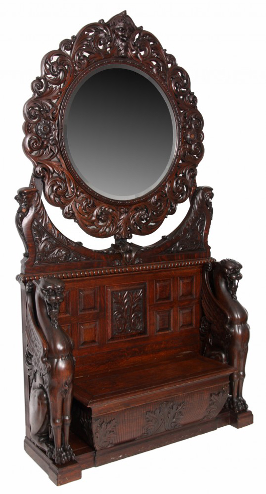 Magnificent oak griffin carved two-piece hall bench with round beveled mirror top, 103 inches tall. Estimate: $8,000-$12,000. Fontaine’s Auction Gallery image.