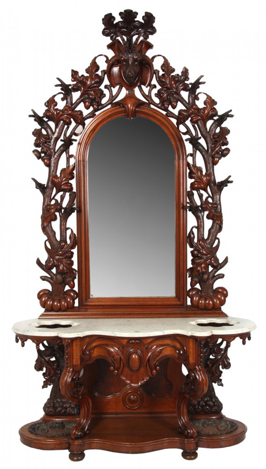 Heavily carved Mitchell & Rammelsberg walnut marble-top hall tree with mirror, 101 inches tall. Estimate: $15,000-$25,000. Fontaine’s Auction Gallery image.