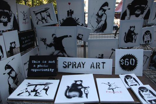 Banksy posted this picture online of the pop-up art stall in Central Park where his original, signed spray paintings were offered for $60 apiece.