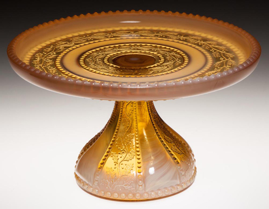 A Greentown No. 450/Holly Amber cake stand in Golden Agate by the Indiana Tumbler & Goblet Co., circa 1903, soared to $2,990. It measured 5 3/8 inches high by 9 1/4 inches diameter. Jeffrey S. Evans & Associates image.