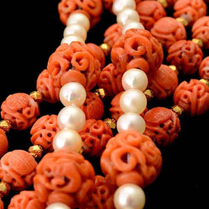 Collection of two carved coral bead, cultured pearl, 14K gold necklaces. Sold for: $16,520. Michaan’s Auctions image.
