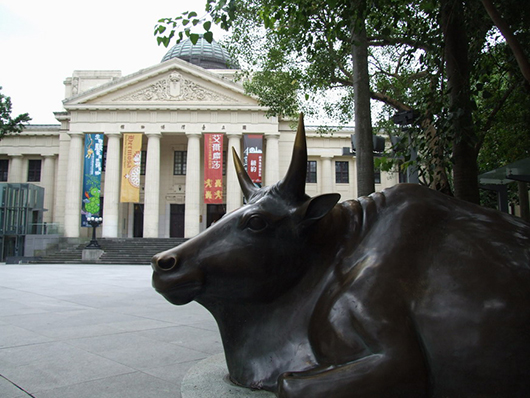 A bronze ox sedately greets visitors as they pass through the gates to the National Taiwan Museum in Taipei. Sept. 12, 2006 photo by James, licensed under the Creative Commons Attribution-Share Alike 3.0 Unported license.
