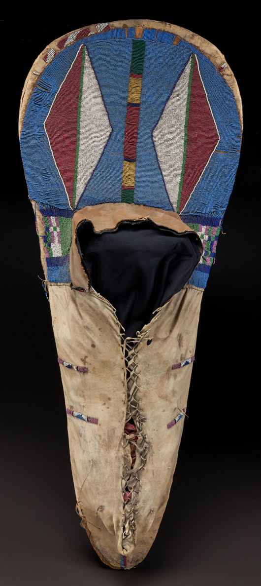 Plateau beaded hide cradleboard, circa 1880, composed of a wood backboard, covered in hide, the bow decorated with a pair of diamonds, flat-stitched in various shades of glass seed beads, hide fringe at back, 41 3/4 inches long. Estimate: $8,000- $12,000. Heritage Auctions image.