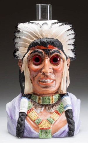 Lot 20A: Bisque Native American Chief / Indian figural miniature lamp, which is considered to be the only known complete example. Price realized: $18,400, a record price for miniature lighting. Jeffrey S. Evans & Associates image.