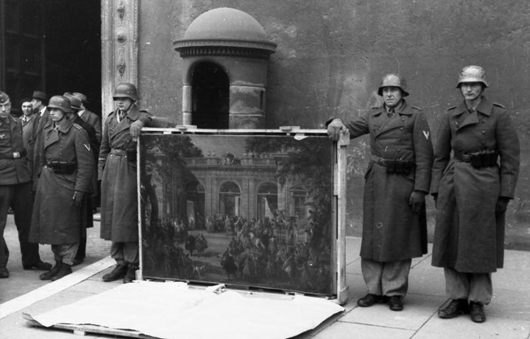German soldiers of the Hermann Göring Division posing in front of Palazzo Venezia in Rome in 1944 with a picture taken from a local museum. This file is licensed under the Creative Commons Attribution-Share Alike 3.0 Germany license.