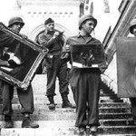 A photo in the U.S. National Archives shows U.S. troops recovering looted paintings from Neuschwanstein Castle in Germany during World War II. Image courtesy of Wikimedia Commons.