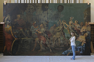 University of Delaware conservator Kristin deGhetaldi standing in front of 'The Triumph of David,' which gives an impression of the scale of Pietro da Cortona's painting. Photo by Steven Crossot, courtesy of Villanova University.