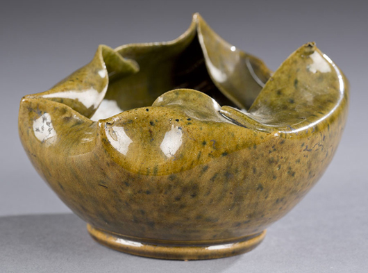 George Ohr small lobed and folded bowl, green glaze. Impressed on bottom: G. E. Ohr, Biloxi, Miss. 1 1/2in h. x 4in dia. Estimate $3,000-$5,000 Quinn's Auction Galleries image.