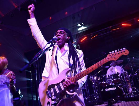 Nile Rodgers performs onstage at the After Party for Jony And Marc's (RED) Auction at Sotheby's on November 23, 2013 in New York City. Photo by Mike Coppola/Getty Images for (RED).