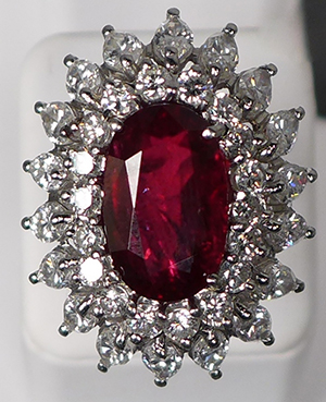 Platinum cocktail ring comprising a 9.91-carat, GIA-certified oval ruby surrounded by 18 round diamonds (approx. 2.21 cts) and 18 marquise-cut diamond (4.16 cts). Est. $12,000-$18,000. Sterling Associates image.