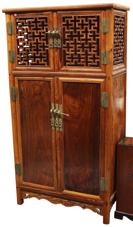 This Chinese wooden cabinet featuring a pair of openwork lattice double doors was expected to sell for $450 but earned an astounding $41,650. Clars Auction Gallery image.