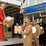 Dressed as Santa, Fellows’ Managing Director Stephen Whittaker and his staff load Christmas gift baskets to be delivered to Ladywood Community Centre in inner-city Birmingham. Fellows & Sons image.