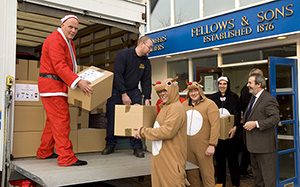 Dressed as Santa, Fellows’ Managing Director Stephen Whittaker and his staff load Christmas gift baskets to be delivered to Ladywood Community Centre in inner-city Birmingham. Fellows & Sons image.