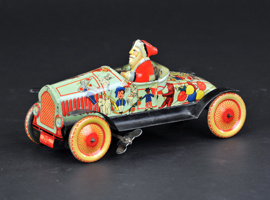 CK prewar Japanese Santa in open roadster decorated with Christmas images, 7in long. Sold for $37,760. Bertoia Auctions image.
