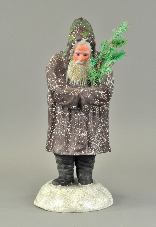 Rare 19-inch German belsnickle depicting Father Christmas with glass icicle beard, garbed in purple robe and holding feather tree. Sold for $20,600. Bertoia Auctions image.