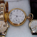 Two men’s gold Rolex wristwatches (left and right) and an 18K gold Tiffany pocket watch. John W. Coker Auctions image.