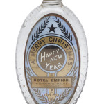 ‘A Merry Christmas, Happy New Year, Hotel Emrich, 485 to 489 Pennsylvania Ave., Washington, D.C.’ is the wording on the label under glass on this antique holiday gift flask. It once held a half pint of whiskey. The bottle sold for $468 at an online Norman C. Heckler bottle auction.