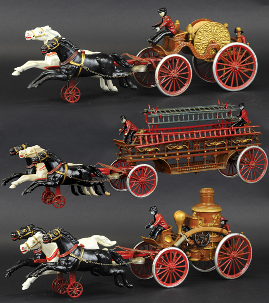 These Dent fire toys are the largest horse-drawn examples of their kind. Each is a replica of the fire equipment used at the turn of the 20th century. Atlantic City Antiques Show image.