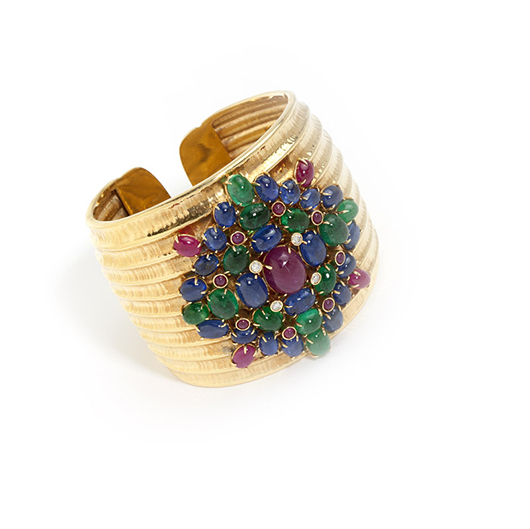 One of a number of striking bangles offered, this 18K gold bangle by Demner, set with rubies, sapphires and emeralds, realized $7,200 (estimate: $3,500-$4,500). John Moran Antique and Fine Art Auctioneers image.