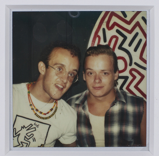 1980s Polaroid photograph of Keith Haring (left) and Martin Burgoyne, with a Haring artwork in the background, estimate $800-$1,200. Myers Fine Art image.