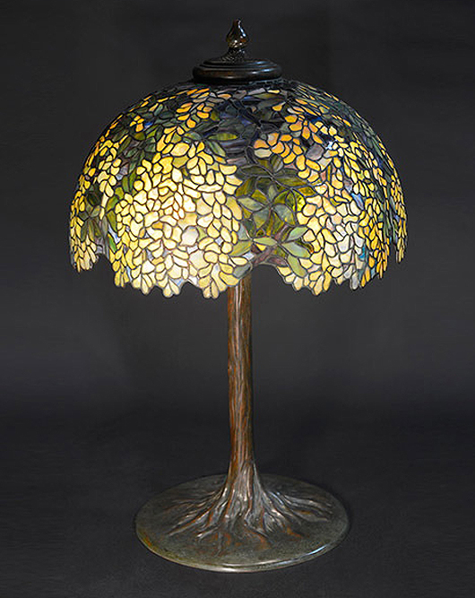 Tiffany Studios Laburnum table lamp on a tree trunk base. Sold for $236,000. Michaan’s Auctions image.
